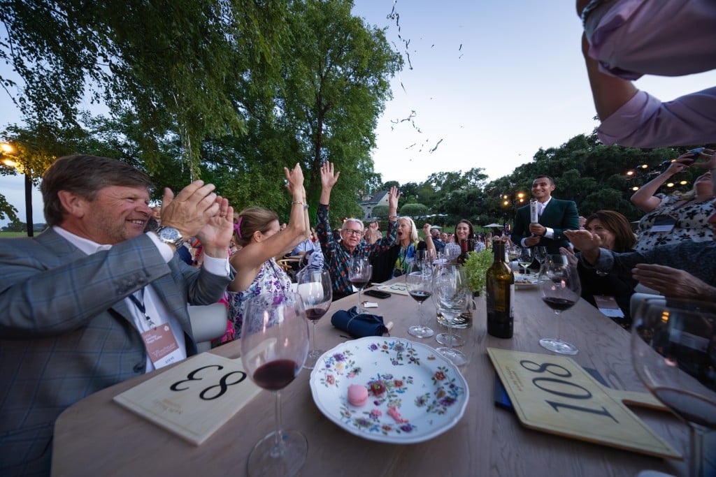Auction attendees enjoy dinner at Auction Napa Valley 2024 - Nighttime live auction. Photo by Chester Cooley